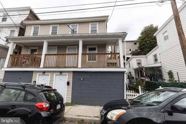 a front view of a house with parking space