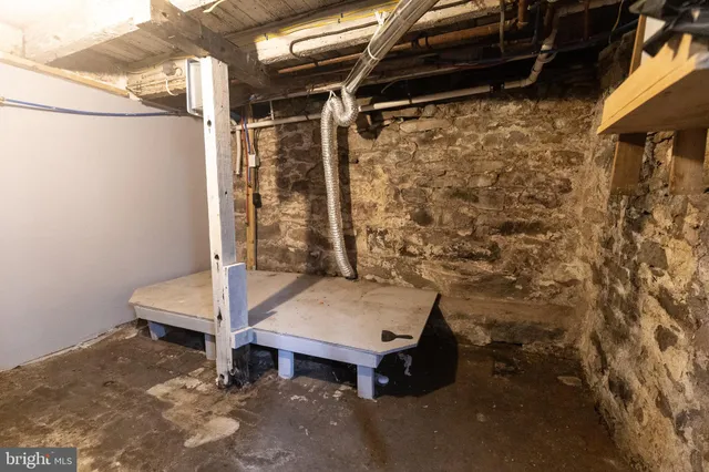 a room with water heater and a wooden door