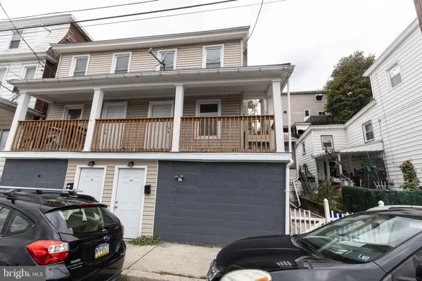 a front view of a house with parking area