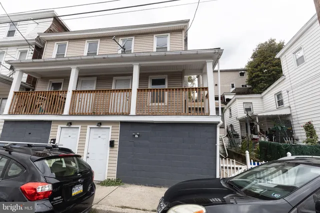 a front view of a house with parking area