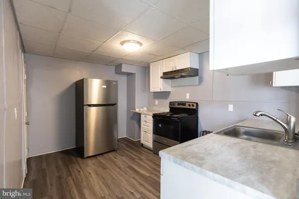 a kitchen with a refrigerator stove and a sink