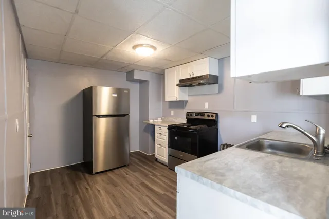 a kitchen with a refrigerator stove and a sink