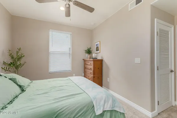 a bedroom with a bed and a potted plant