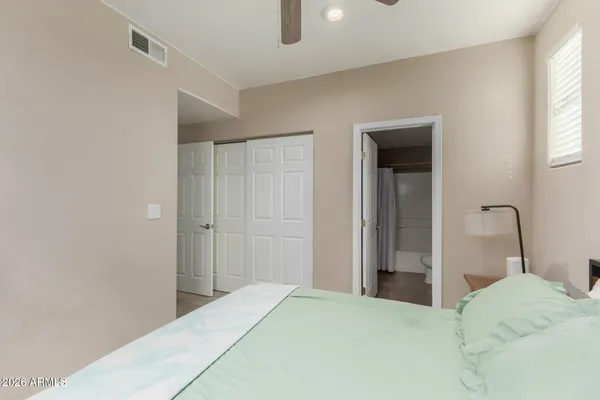 a bedroom with a bed and a window