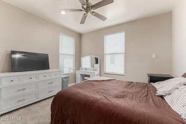 a bedroom with a large bed and a flat screen tv