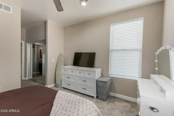 a view of a bedroom with workspace and window