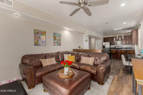 a living room with furniture and kitchen view