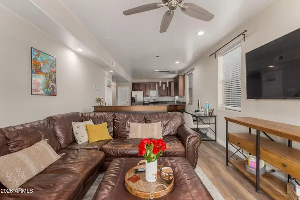 a living room with furniture and flowers