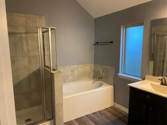 a bathroom with a bathtub and a sink