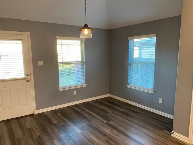 a view of wooden floor and windows in a room