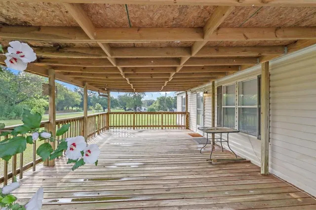 a view of a room with wooden floor and windows