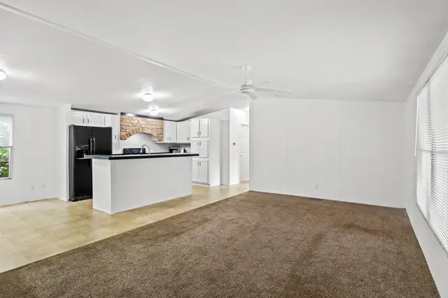 a view of a kitchen with a refrigerator a stove top oven and a refrigerator
