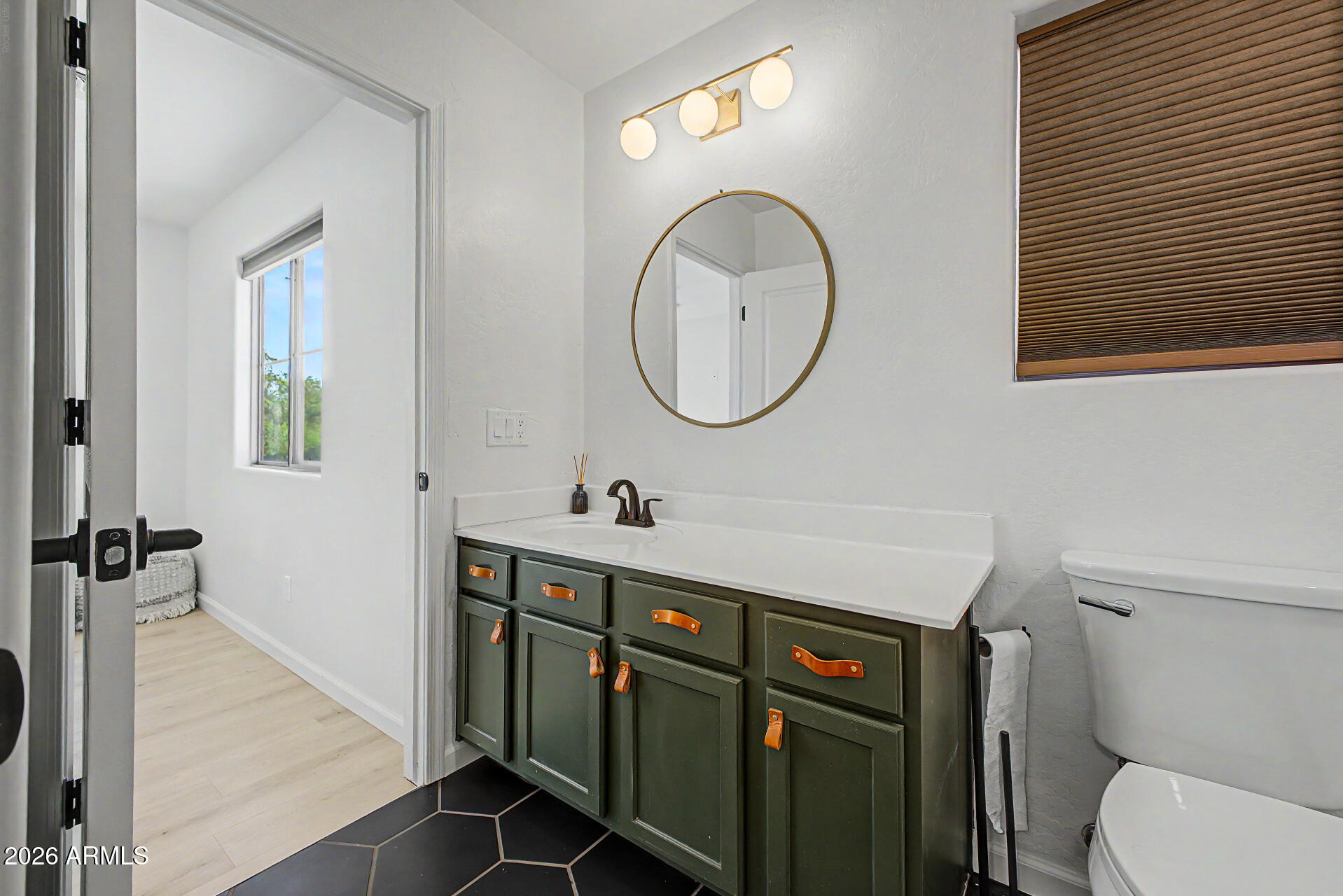 451 South Hawes Road, Unit 27 Mesa, AZ 85208 - Photo 21 of 27 a bathroom with a toilet a sink and mirror