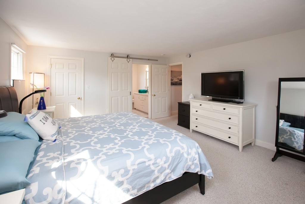 44 Kenneth Road Scituate, MA 02066 - Photo 16 of 30 a spacious bedroom with a bed and a flat screen tv