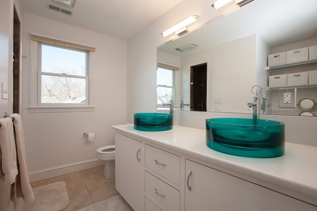 44 Kenneth Road Scituate, MA 02066 - Photo 17 of 30 a bathroom with a double vanity sink and a toilet