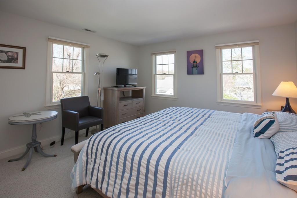 44 Kenneth Road Scituate, MA 02066 - Photo 19 of 30 a bedroom with a bed and a chair in it