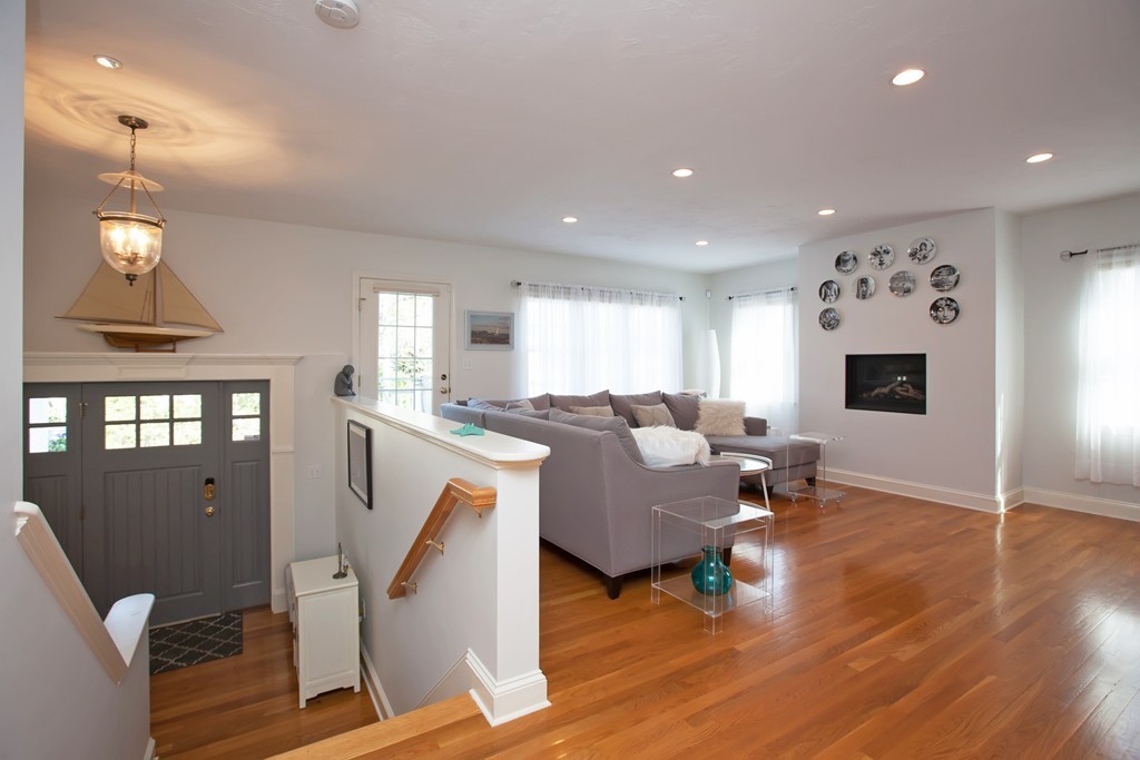 44 Kenneth Road Scituate, MA 02066 - Photo 4 of 30 a living room with furniture a fireplace and a chandelier
