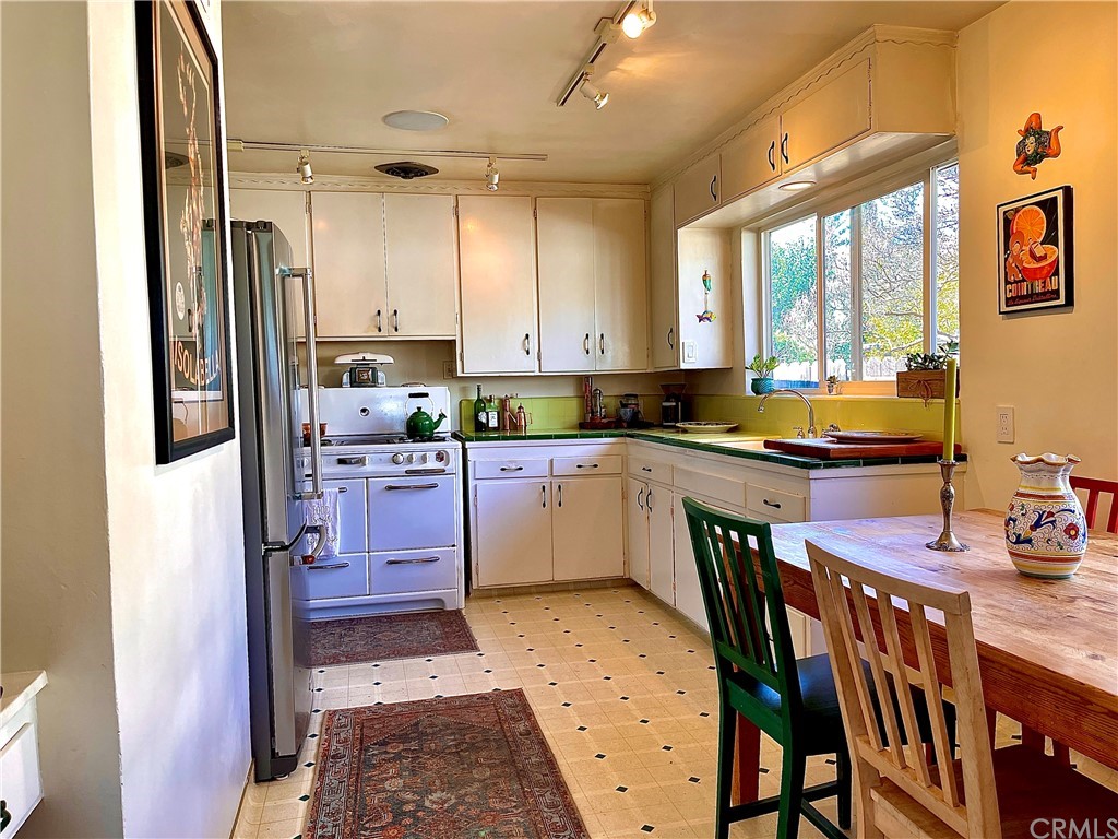 1245 Palm Avenue Chico, CA 95926 - Photo 5 of 19 a kitchen with a table chairs refrigerator and window