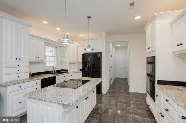 a dining room with furniture and chandelier kitchen view