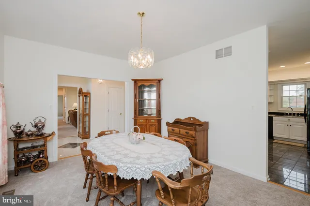 a spacious bedroom with a bed and a chandelier