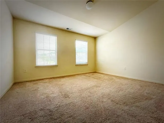 an empty room with a empty space and windows