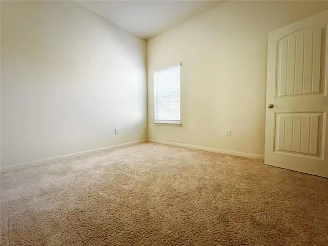 an empty room with a windows