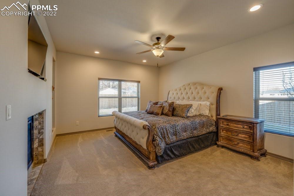 119 Rocchio Drive Florence, CO 81226 - Photo 15 of 48 a spacious bedroom with a bed and a flat tv screen on dresser