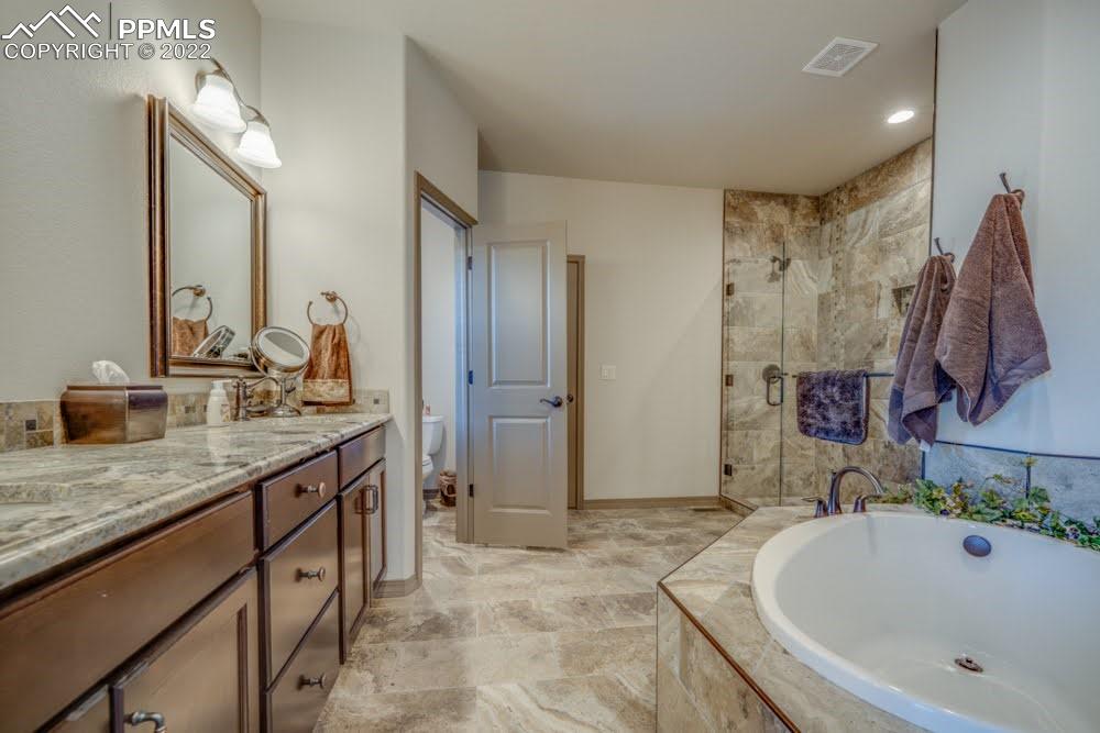 119 Rocchio Drive Florence, CO 81226 - Photo 18 of 48 a spacious bathroom with a granite countertop sink and a mirror