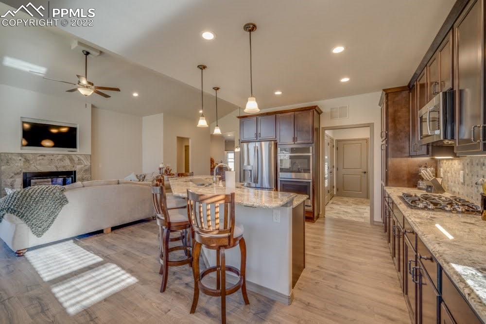 119 Rocchio Drive Florence, CO 81226 - Photo 29 of 48 a living room with stainless steel appliances kitchen island granite countertop furniture wooden floor and a view of kitchen