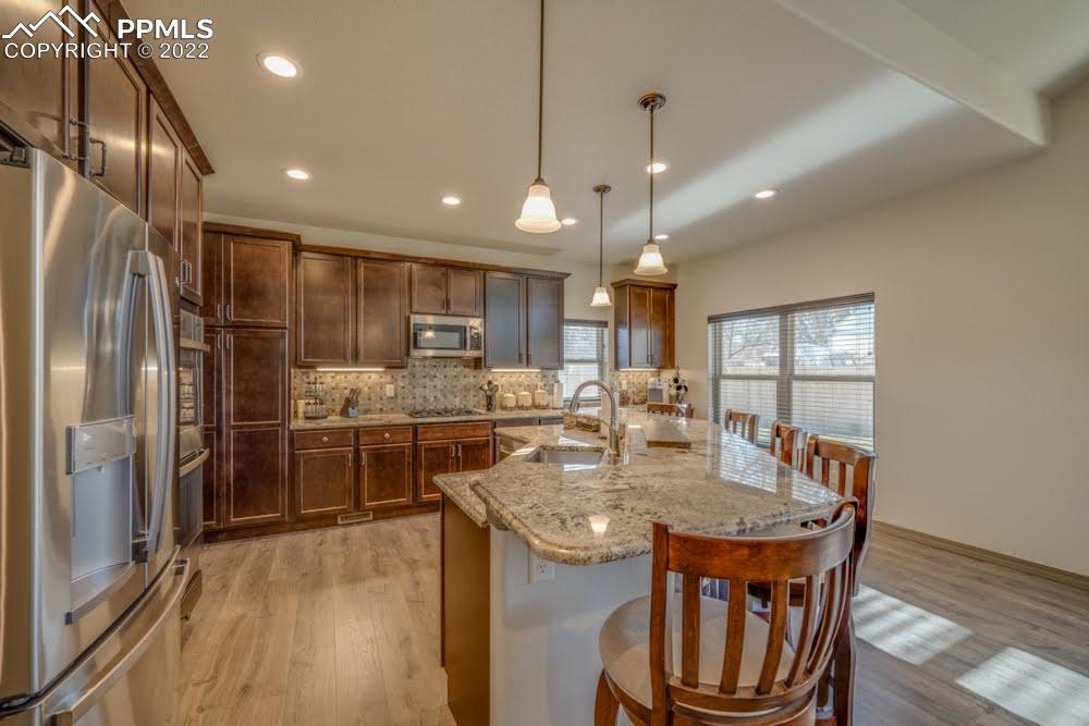 119 Rocchio Drive Florence, CO 81226 - Photo 32 of 48 a kitchen with stainless steel appliances granite countertop a kitchen island a stove a refrigerator a oven a sink with a dining table and chairs