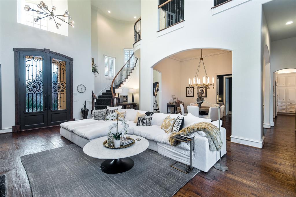 6601 Riverhill Drive Plano, TX 75024 - Photo 1 of 1 a living room with furniture a large window and wood floor