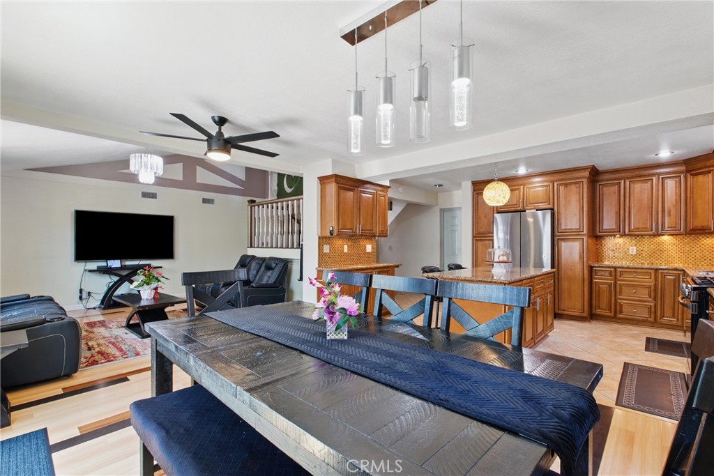 302 East 213th Street Carson, CA 90745 - Photo 15 of 40 a living room with furniture a flat screen tv and kitchen view