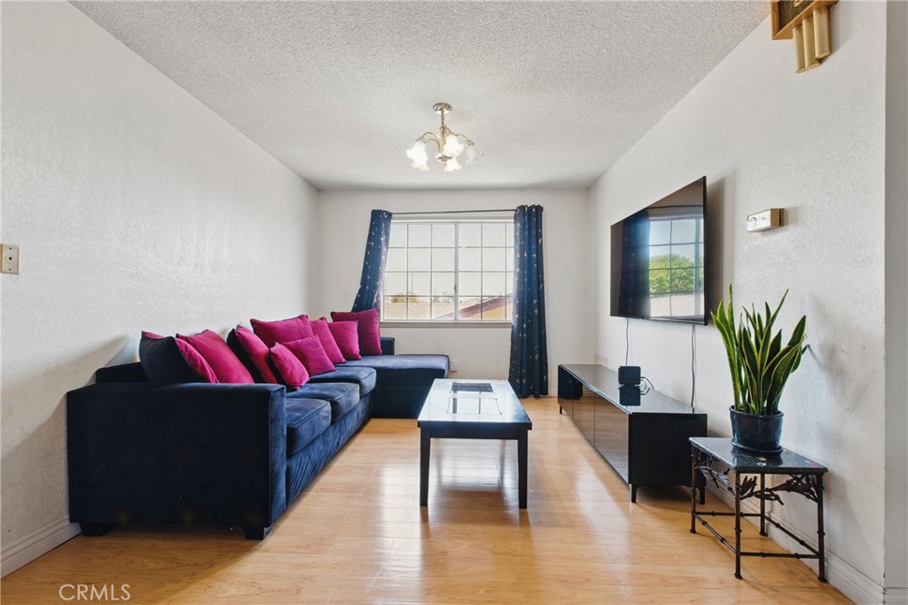 302 East 213th Street Carson, CA 90745 - Photo 22 of 40 a living room with furniture and a wooden floor