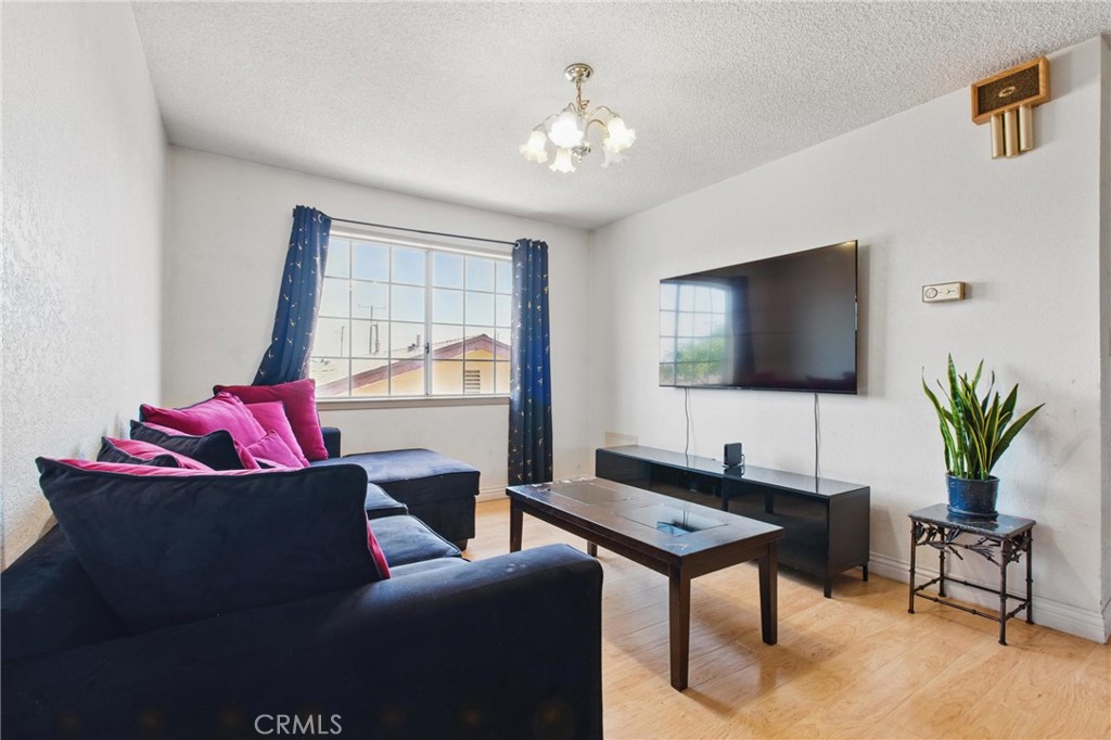 302 East 213th Street Carson, CA 90745 - Photo 23 of 40 a living room with furniture and a flat screen tv