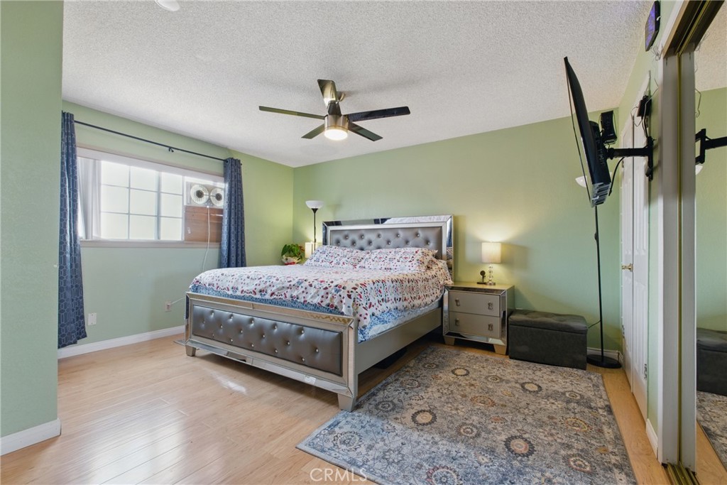 302 East 213th Street Carson, CA 90745 - Photo 24 of 40 a bedroom with a bed rug and wooden floor