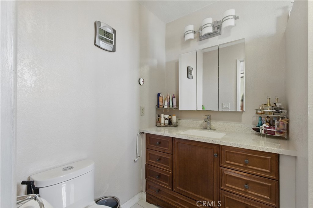 302 East 213th Street Carson, CA 90745 - Photo 25 of 40 a bathroom with a sink and a mirror