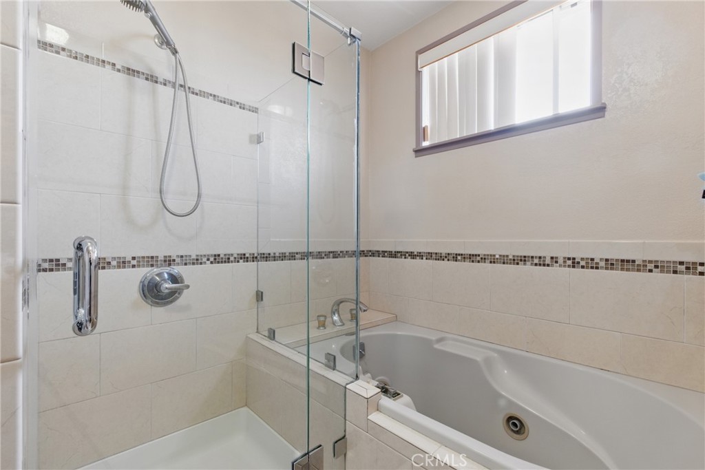 302 East 213th Street Carson, CA 90745 - Photo 26 of 40 a bathroom with a bathtub a shower and vanity