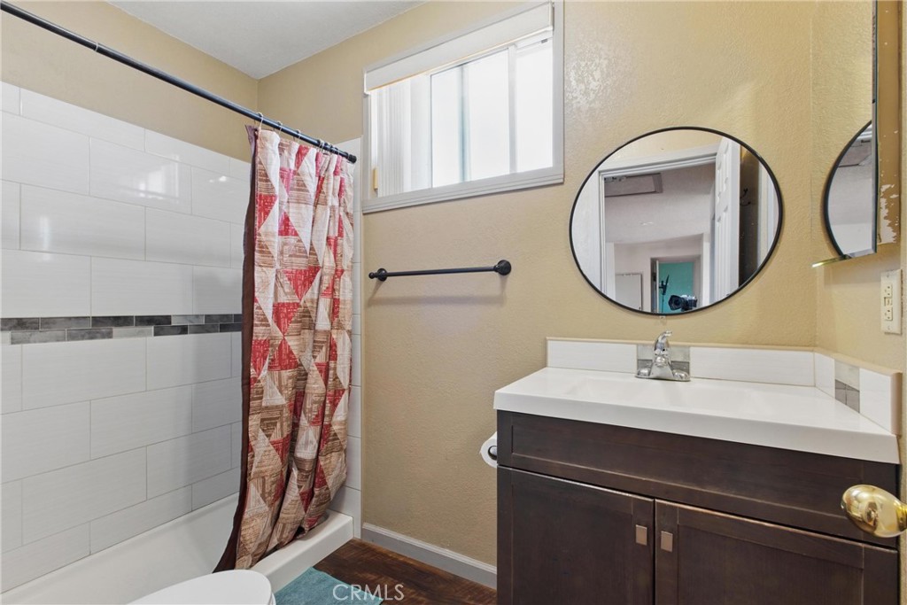 302 East 213th Street Carson, CA 90745 - Photo 30 of 40 a bathroom with a sink and a mirror
