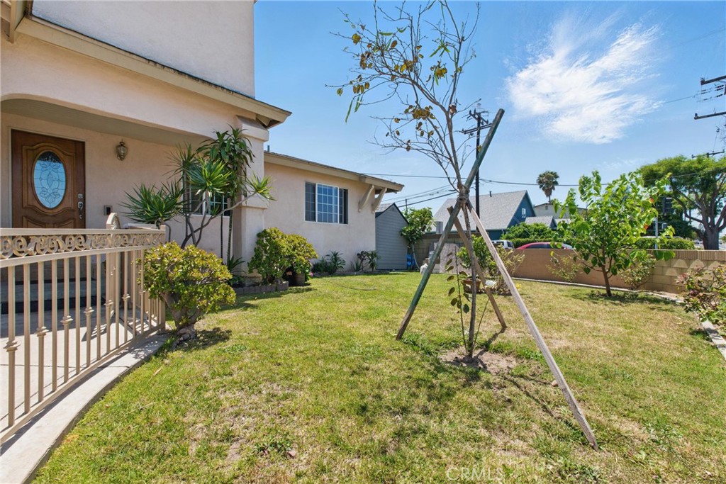 302 East 213th Street Carson, CA 90745 - Photo 3 of 40 a view of a house with a tree in a yard