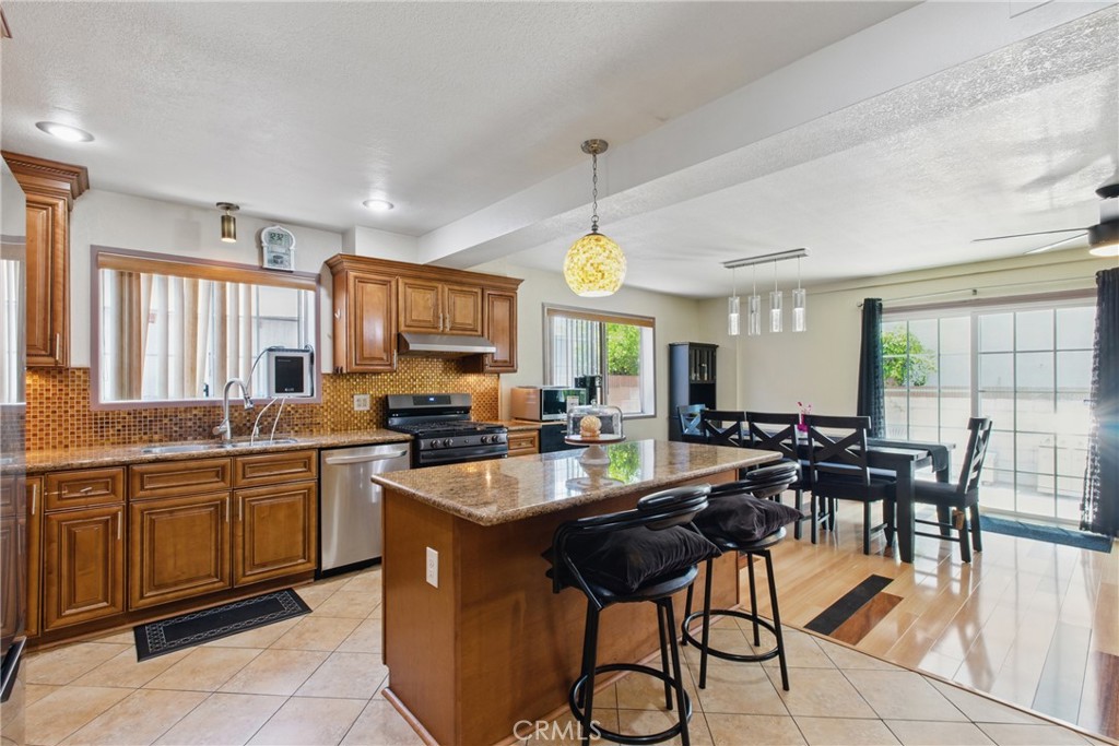 302 East 213th Street Carson, CA 90745 - Photo 5 of 40 a kitchen with a dining table and chairs
