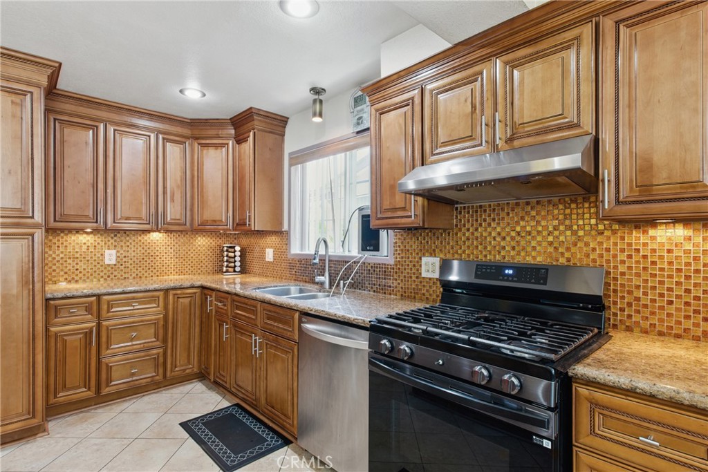 302 East 213th Street Carson, CA 90745 - Photo 7 of 40 a kitchen with a sink stove top oven
