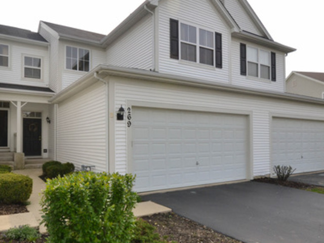 a front view of a house with garage