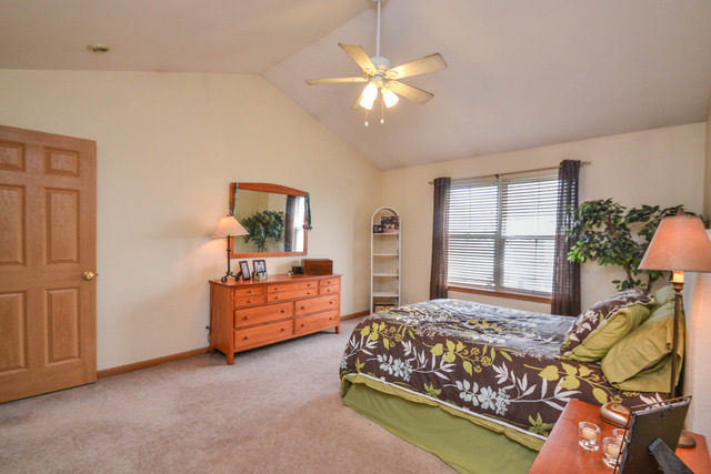 269 Grand Ridge Road, Unit 269 St. Charles, IL 60175 - Photo 12 of 25 a bedroom with a bed and window