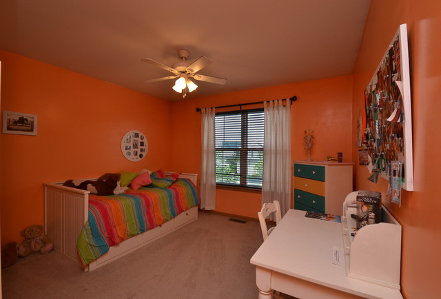 269 Grand Ridge Road, Unit 269 St. Charles, IL 60175 - Photo 15 of 25 a bedroom with furniture and a chandelier