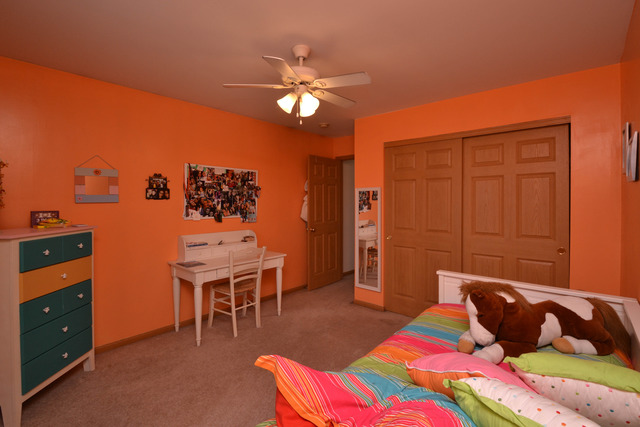 269 Grand Ridge Road, Unit 269 St. Charles, IL 60175 - Photo 17 of 25 a bedroom with a bed and a chandelier