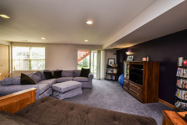 269 Grand Ridge Road, Unit 269 St. Charles, IL 60175 - Photo 18 of 25 a living room with furniture and a flat screen tv