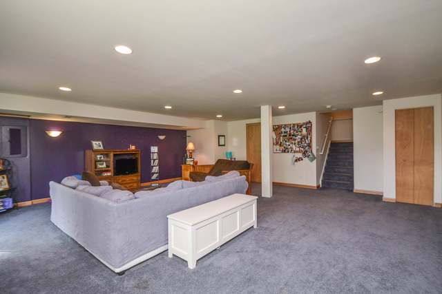 269 Grand Ridge Road, Unit 269 St. Charles, IL 60175 - Photo 19 of 25 a living room with furniture and a flat screen tv