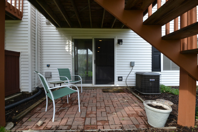 269 Grand Ridge Road, Unit 269 St. Charles, IL 60175 - Photo 23 of 25 a view of a patio with table and chairs and wooden fence