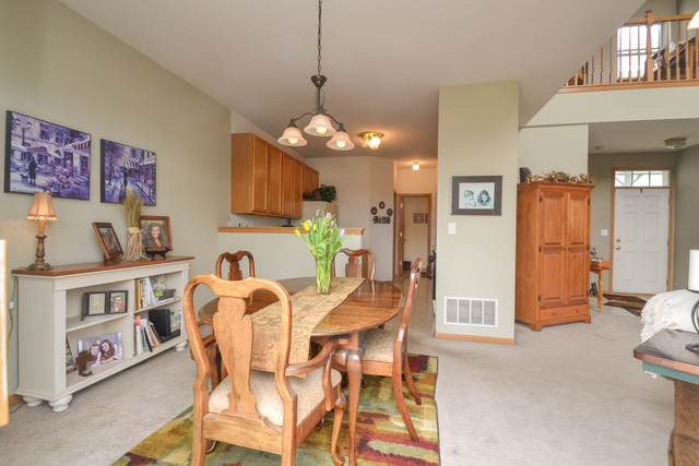 269 Grand Ridge Road, Unit 269 St. Charles, IL 60175 - Photo 6 of 25 a view of a dining room with furniture and chandelier