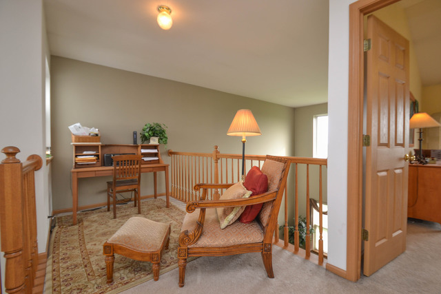 269 Grand Ridge Road, Unit 269 St. Charles, IL 60175 - Photo 10 of 25 a living room with furniture and a lamp